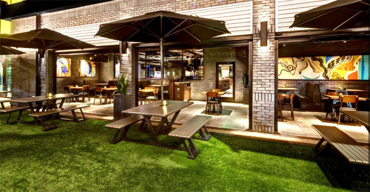 Outdoor site furnishings — metal tables and benches at Yard House, Sarasota FL